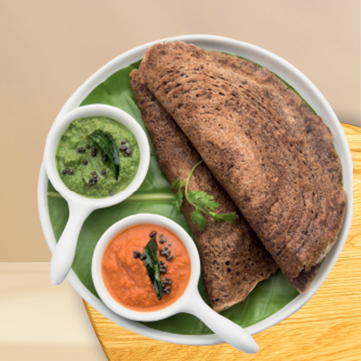 Ragi Masala Dosa with chutney served on green leaf plate